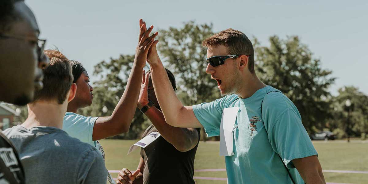 Two students high-fiving each other